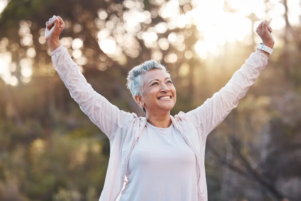 healthy woman raising arms, enjoying life