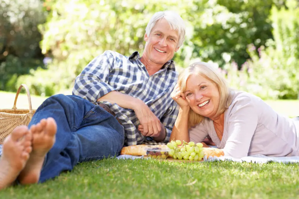 Senior couple with picnic in park